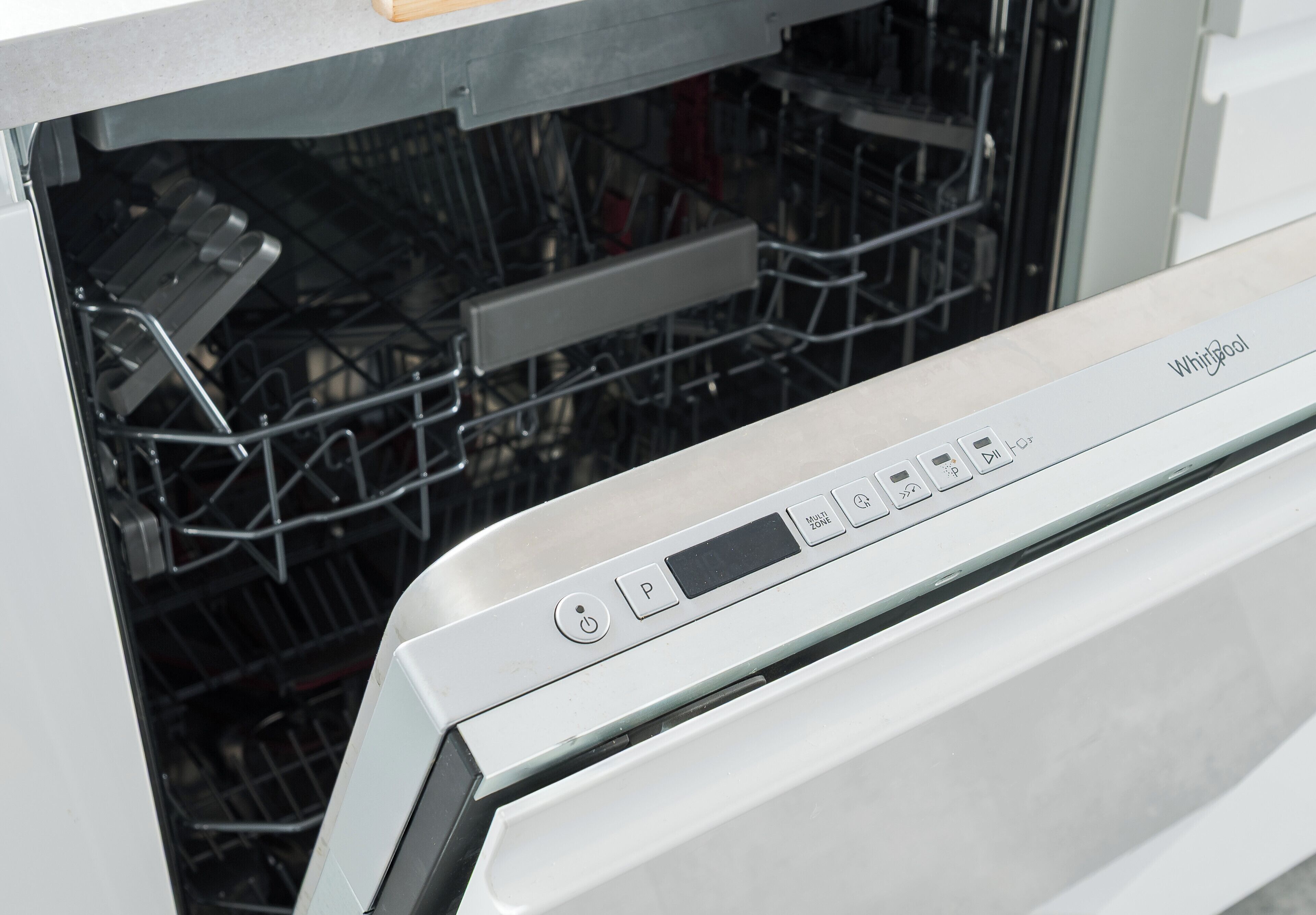 A dishwasher with a control panel and a rack of dishes inside.