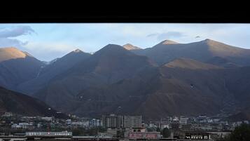 A mountainous landscape with a town in the foreground.