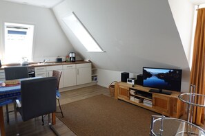 A modern loft apartment with a kitchen, dining area, and living space. - Paluch Vacation Apartment - Bright, 1st-floor unit (Wyk auf Föhr)