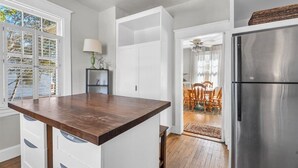 A kitchen with white cabinetry, a wooden countertop, and a stainless steel refrigerator. - Lakeside Vintage Retreat | Classic RVA Charm (Henrico)