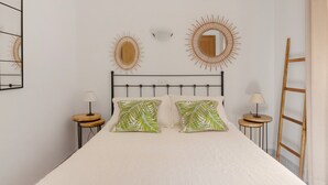 A bedroom with a bed, two bedside tables, a headboard, and wall decorations. - Holiday Home 'Ca N'Alicia Des Bosch' with Mountain Views, Private Terrace and Wi-Fi (Illes Balears)