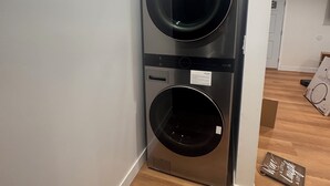 A compact, modern laundry room with two stacked washing machines. - Charming 2-bedroom house with WiFi, AC in welcoming Long Beach (Long Beach)