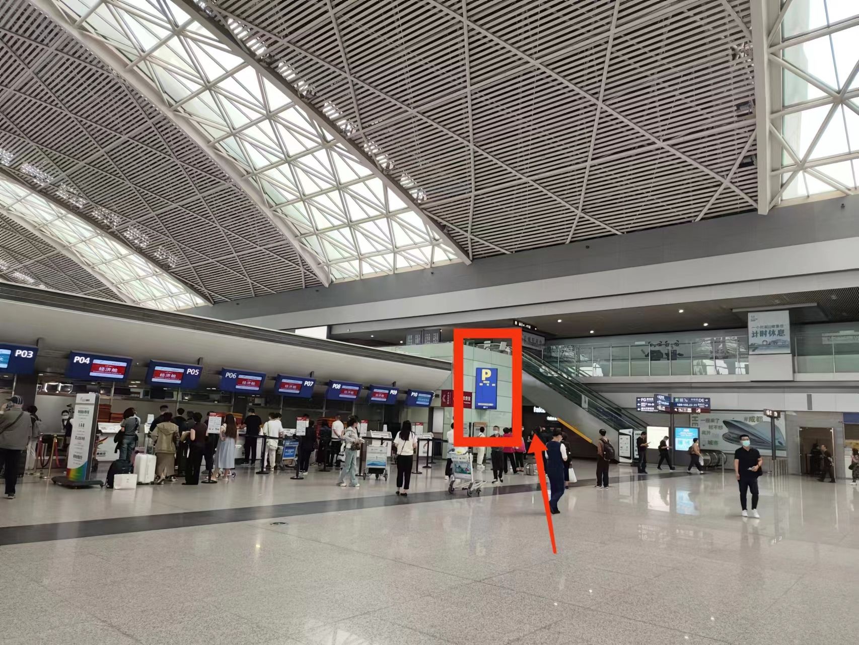 A spacious airport terminal with a high ceiling and a modern design.