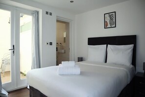 2 habitaciones, escritorio y tabla de planchar con plancha