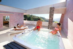 A rooftop pool area with a hot tub, lounge chairs, and a view of the surrounding landscape. - Villa Liana - Private villa with pool (Sant'Agata Sui Due Golfi)