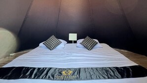 A room with a bed, two bedside tables, and a ceiling light fixture. - Regan Luxcamp by Digihub Hospitality (Pangalengan)
