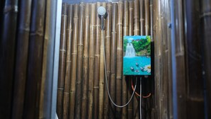 A bamboo shower enclosure with a toilet. - Regan Luxcamp by Digihub Hospitality (Pangalengan)