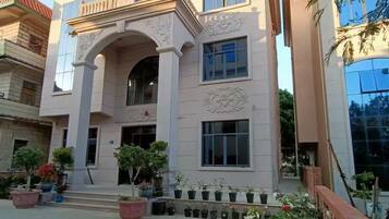 A building with a symmetrical facade, multiple windows, and a central entrance with decorative arches.