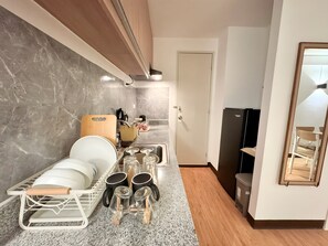 Fridge, stovetop, electric kettle, cookware/dishes/utensils