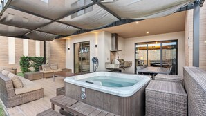 A covered outdoor patio with wicker furniture, a hot tub, and a wooden deck. - 4BR house with private hot tub in kissimmee (Kissimmee)