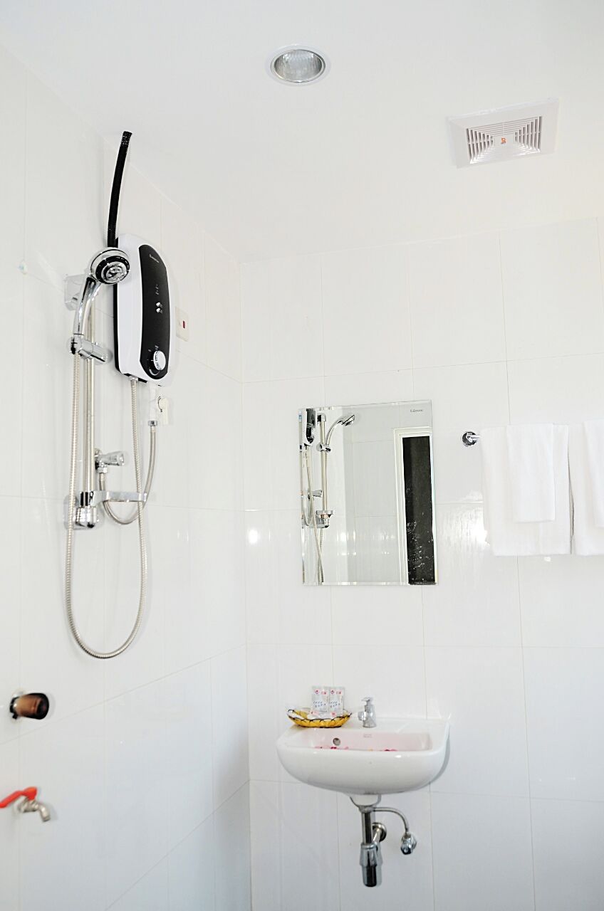 A bathroom with a shower, a sink, and a mirror.