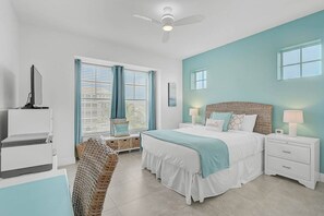 A bedroom with a bed, bedside tables, a desk, and a chair. - Margaritaville Condo, Gated Resort, Pool & Beach! (Bradenton)