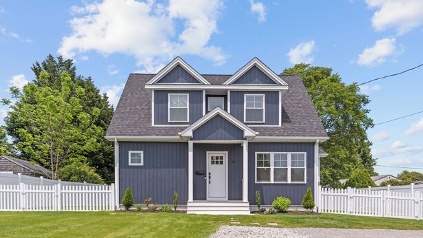 A two-story house with a gray exterior, white trim, and a front porch. - Ideally located, game room, finished basement, fenced yard, lawn games, coffee (Middletown)
