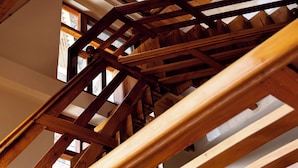 A wooden staircase with multiple levels and open skylights. - Namgials by Sky Group (Manali)