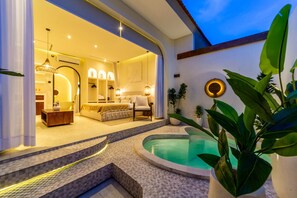 A modern interior with a pool area, including a bedroom with a bed and a seating area, and a dining space with a table and chairs. - 1BR Romantic Designer Villa with Private Pool, Canggu by Orivista (Canggu)