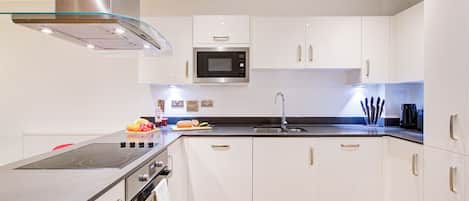 Fridge, stovetop, dishwasher, coffee/tea maker