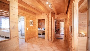 A wooden cabin interior with a bedroom, bathroom, and kitchen area. - Apartment 'Horizonte' with Balcony and Wi-Fi (Oberkirch)