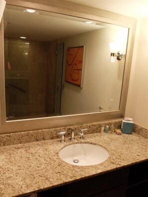 A bathroom with a large mirror, granite countertop, and a sink. - Luxury Hotel GalleryOne by The Sea-Fort Lauderdale (Fort Lauderdale)
