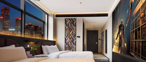 A modern hotel room with a large bed, a city view, and a unique wall art piece.