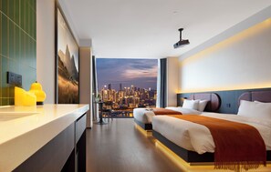 Ein modernes Hotelzimmer mit Blick auf die Stadt, einem großen Bett, einem Schreibtisch und einem Badezimmer.