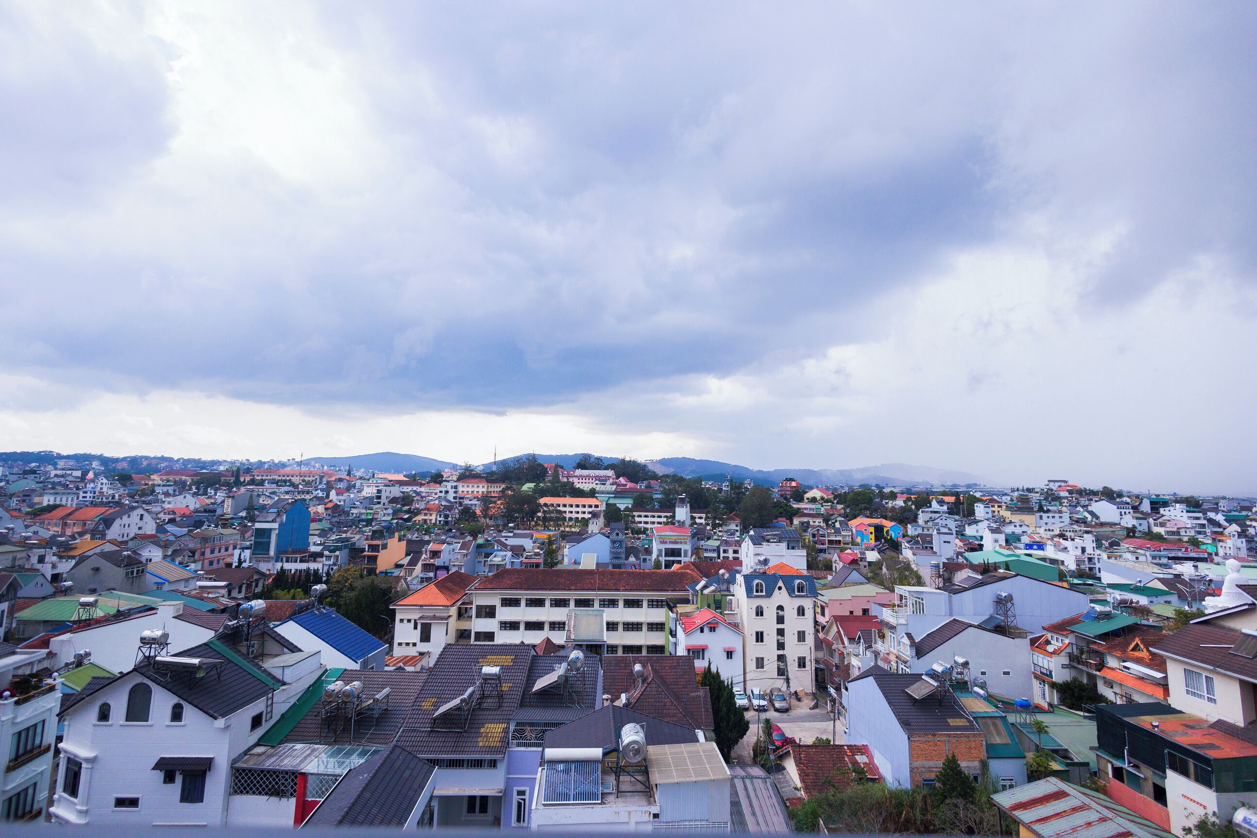 A densely packed urban area with a variety of building styles and rooftops.