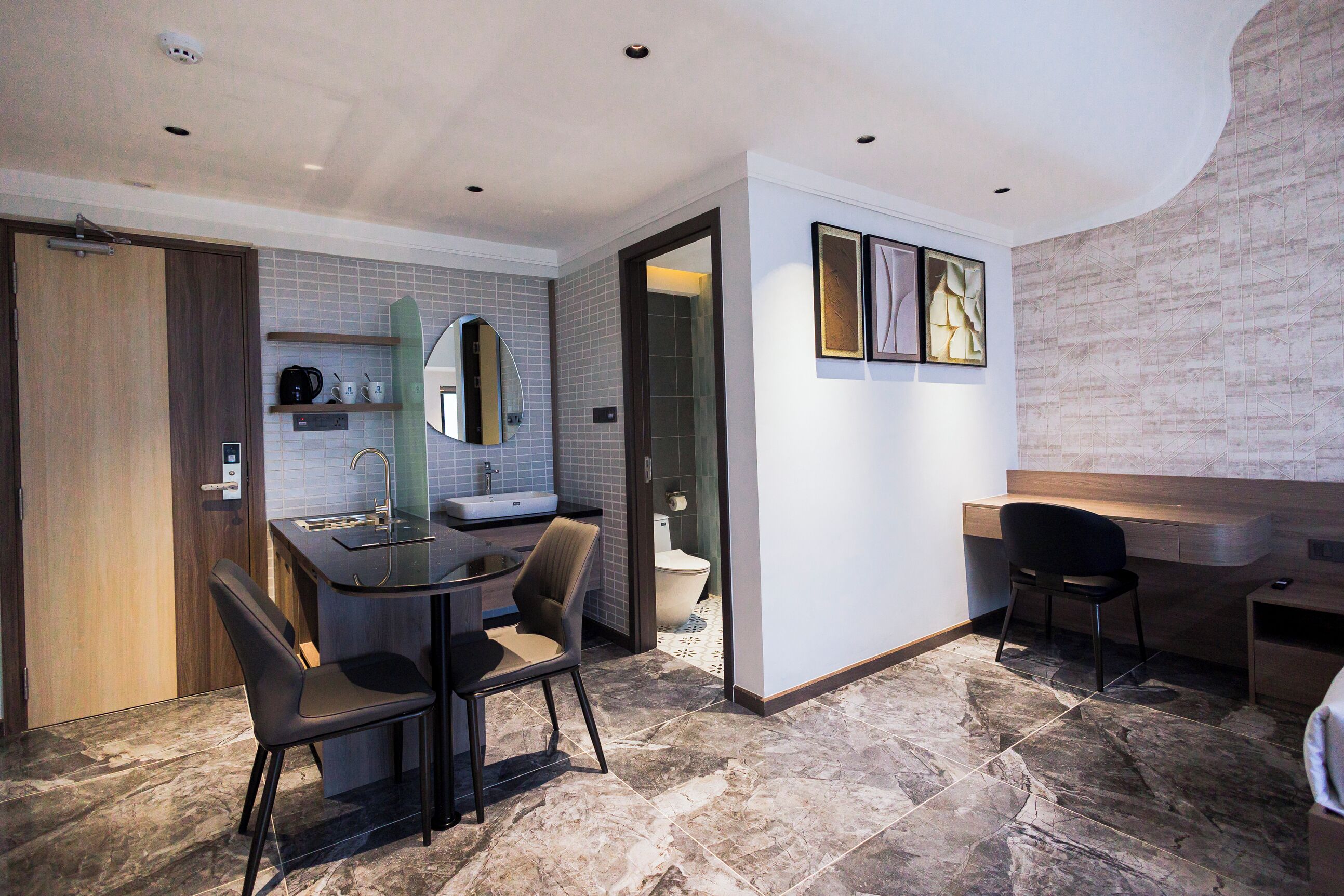 A modern bathroom with a shower, toilet, and sink.