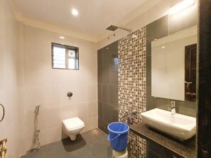 A modern bathroom with a toilet, bidet, and sink. - Omkar Villa (Moleshwar)
