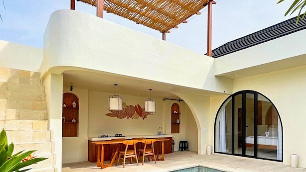 A modern outdoor kitchen with a pool, stone steps, and a covered seating area. - Esha Private Pool Villas by AGATA (Ungasan)