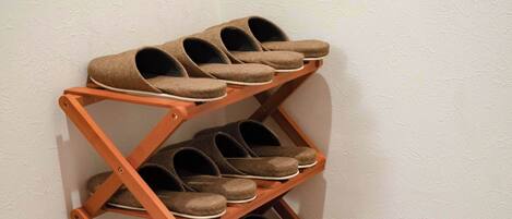 A shoe rack with multiple shelves holding shoes.
