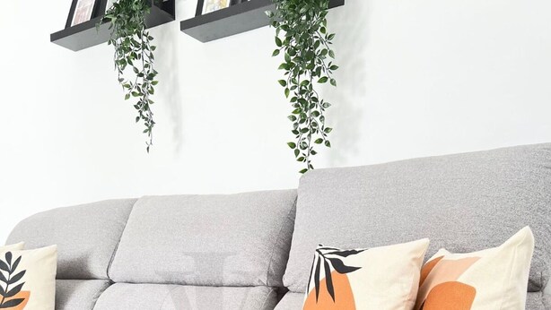 A grey sofa with two decorative pillows and a mustard-colored throw blanket. - Sea and Beach (Puerto del Carmen)