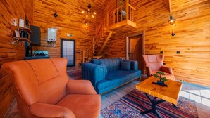 A wooden interior with a sofa, chairs, and a small table. - SAPANCA GRANDWOODEN SUİT  (Sapanca)
