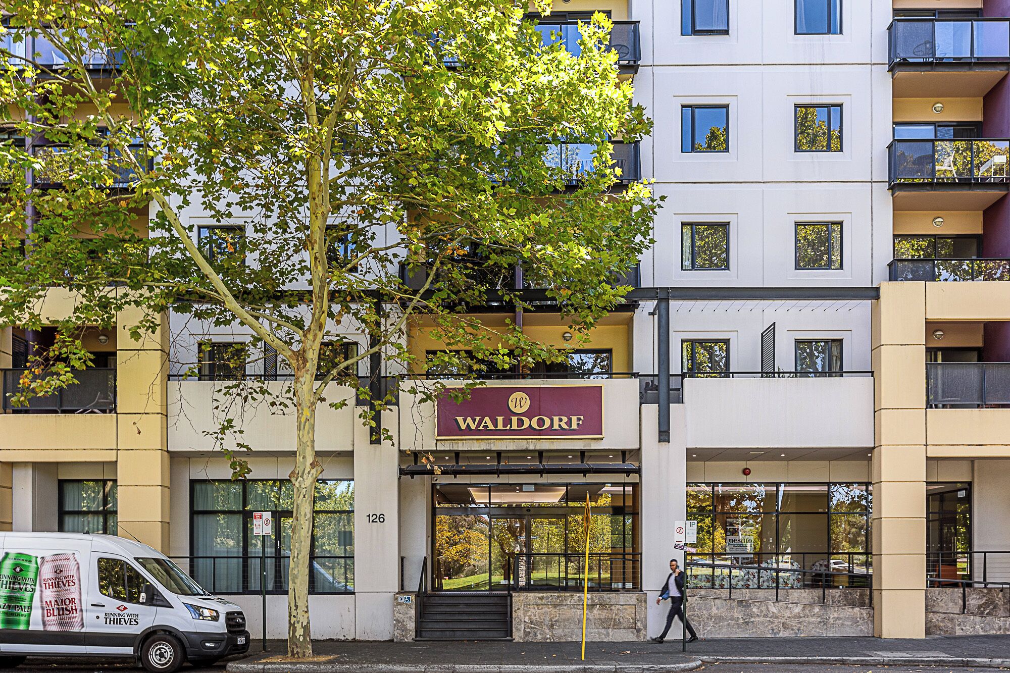 A multi-story building with a sign reading "Waldorf."