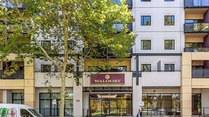 A multi-story building with a sign reading "Waldorf." - Luxury Perth Getaway: Modern Design (Perth WA)