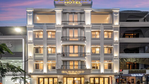 A multi-story hotel with a classic facade, large windows, and a prominent entrance. - Elegant Hotel (Hue)