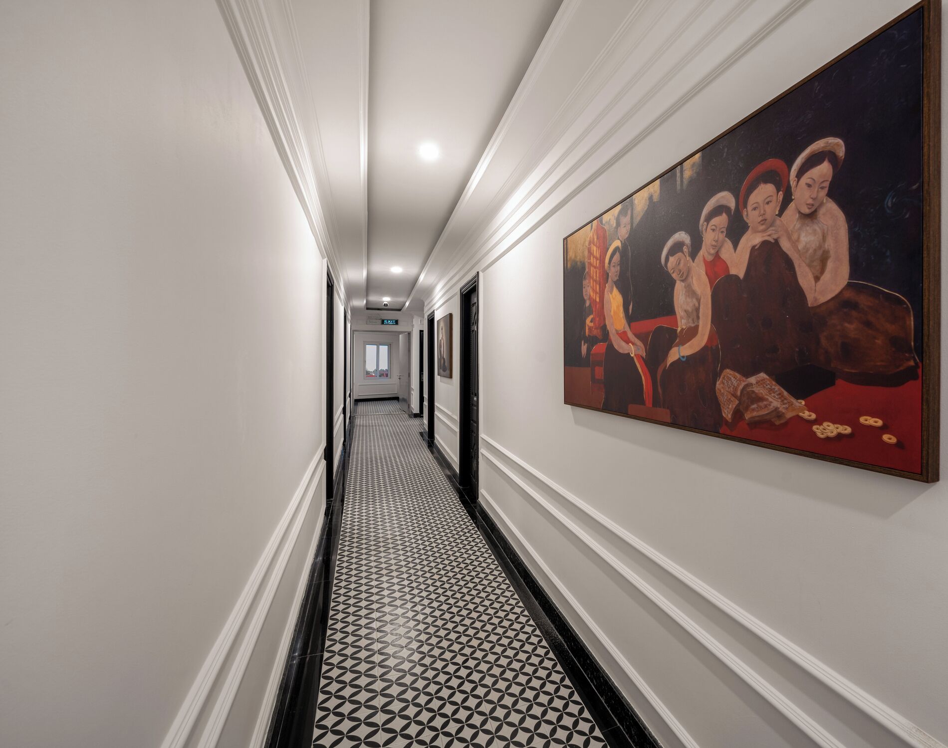 A hallway with a patterned floor, a painting on the wall, and doors leading to rooms.