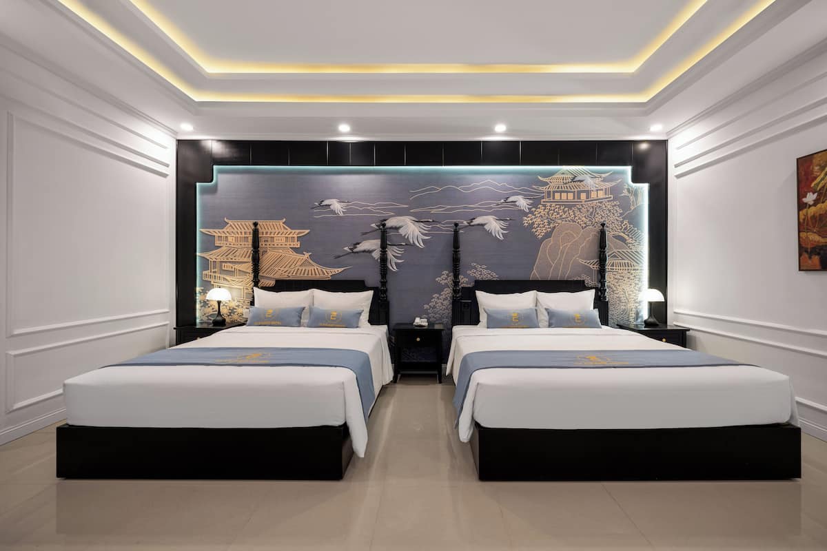 A hotel room with two beds, a large wall mural, and a modern ceiling design.