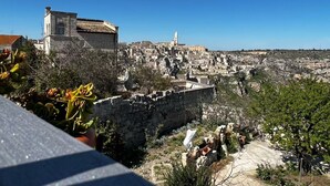 A historic town with stone buildings and a prominent tower. - In the heart of the Sassi of Matera at 500 mt. from the historic center, apartment Deluxe (Matera)
