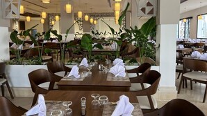 A restaurant with tables set for dining, featuring modern decor and large windows. - One Resort Premium  (Hammamet)