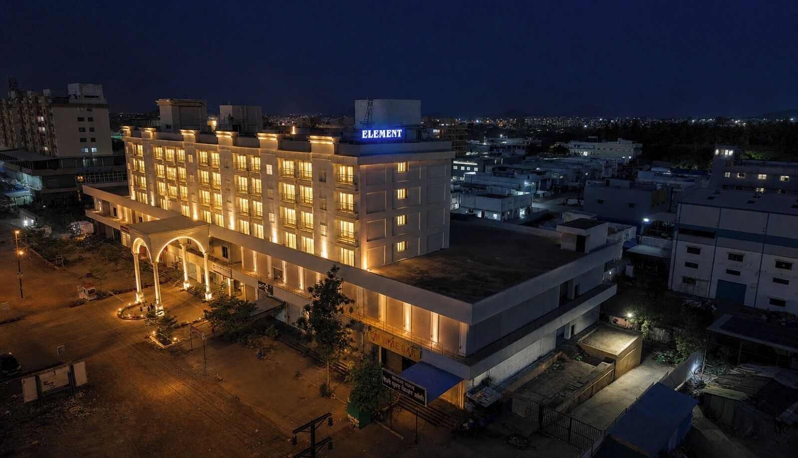A multi-story hotel with a prominent 'ELEMENT' sign, a covered outdoor area, and a parking lot.