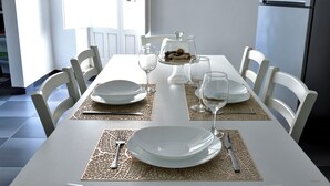 A dining table set with plates, cutlery, and a glass of water. - The Little White House (cozy little single house in the center) (Modica)