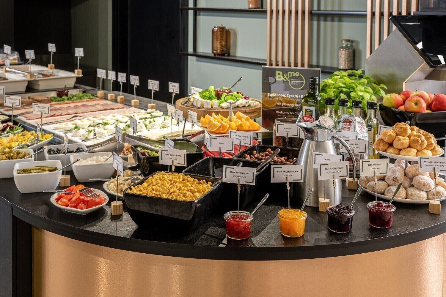 A buffet with various food items and condiments.