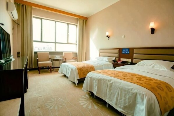A hotel room with two beds, a desk, a chair, a window with curtains, and wall-mounted lamps. - Yudu Hotel (Hotan City)