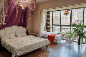 A bedroom with a large bed, a smaller bed, a window with curtains, a hanging light fixture, and a potted plant. - Kunming Mumu Xiaozhan (Chenggong University Town) (Kunming)