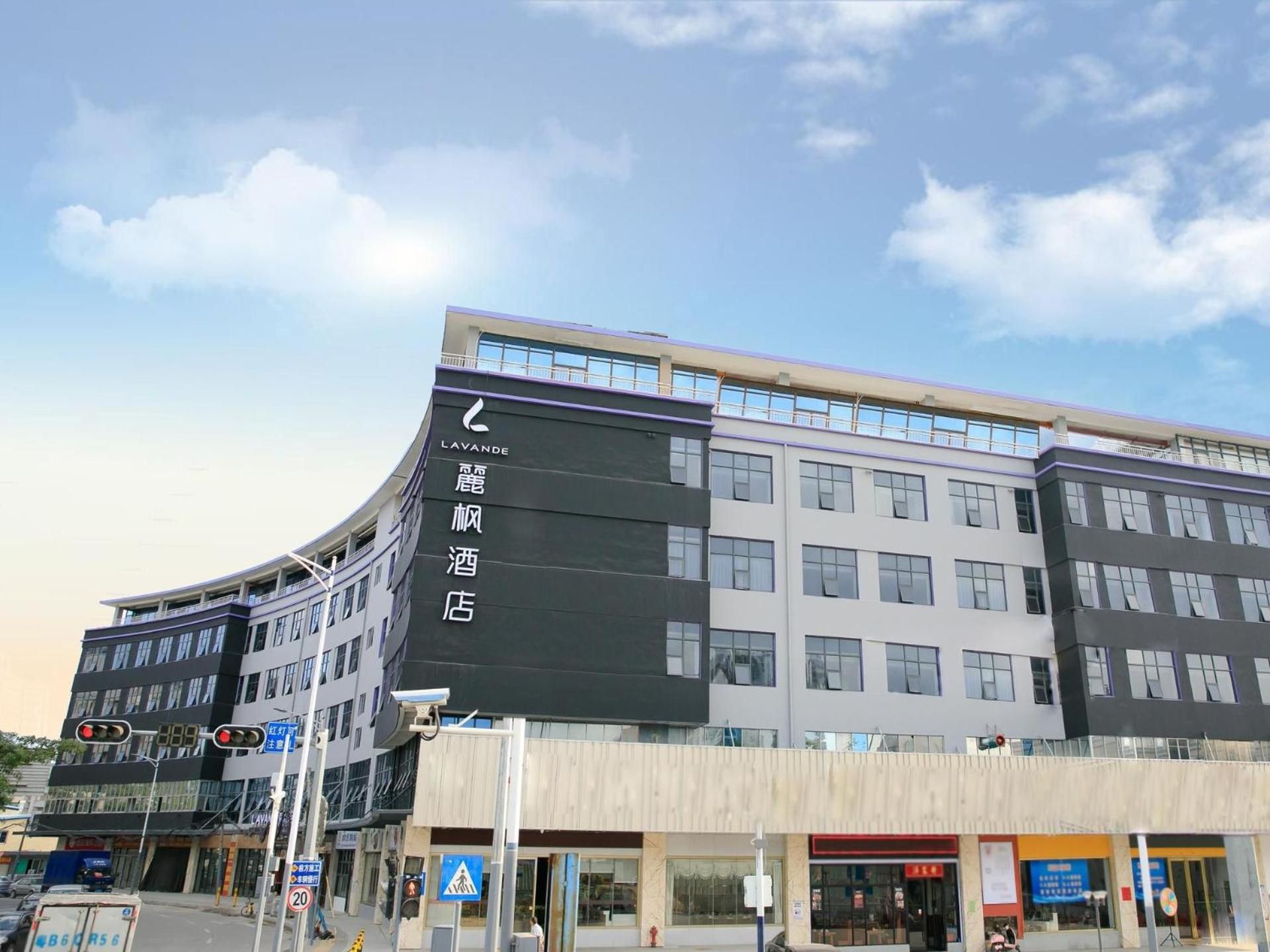 A multi-story hotel with a prominent digital signboard displaying hotel information.