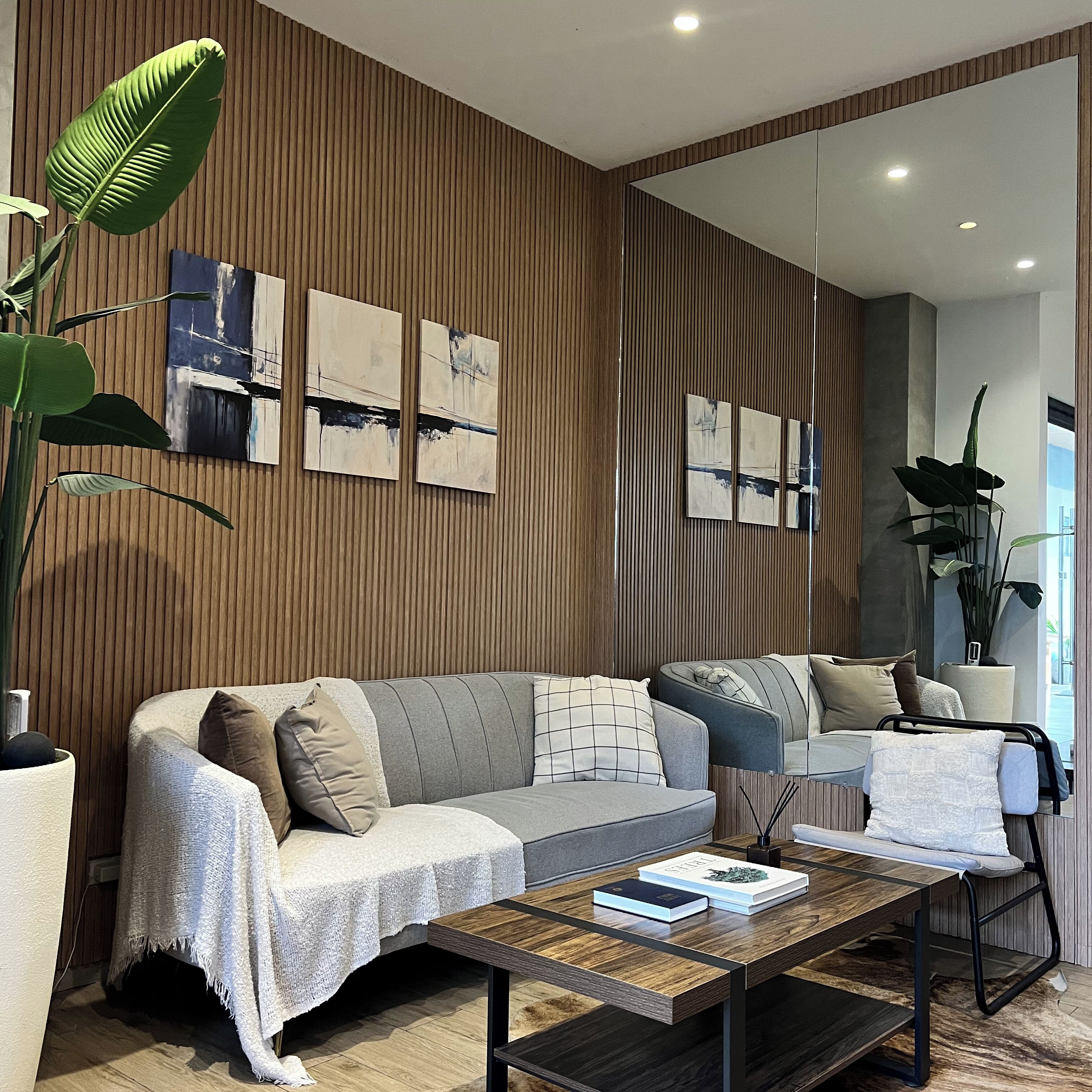 A modern living room with a sofa, coffee table, and artwork on the wall.