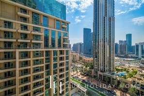 A high-rise building with multiple balconies and a modern glass facade. - LUX  Burj Khalifa Fountain View Suite 2 (Dubai)
