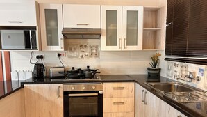 A modern kitchen with a built-in oven, stovetop, and microwave.