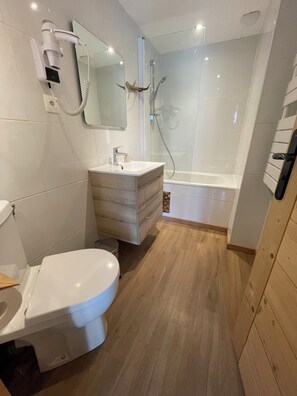Shower, hair dryer, towels, toilet paper