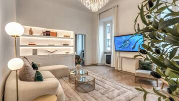 A modern living room with a sofa, coffee table, and TV.