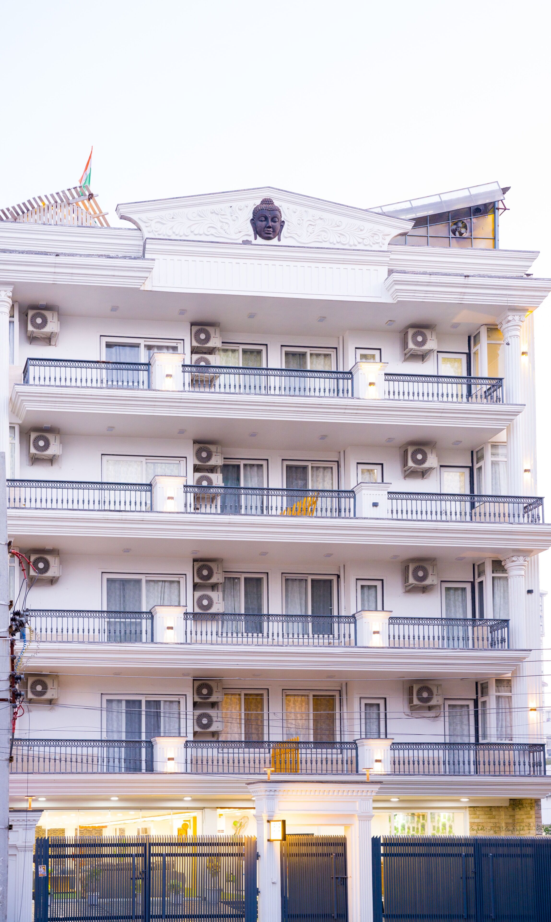 A multi-story building with balconies, air conditioning units, and a traditional architectural design.
